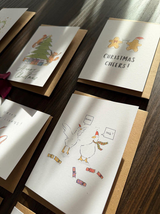 Set of Christmas-themed greeting cards on a wooden surface