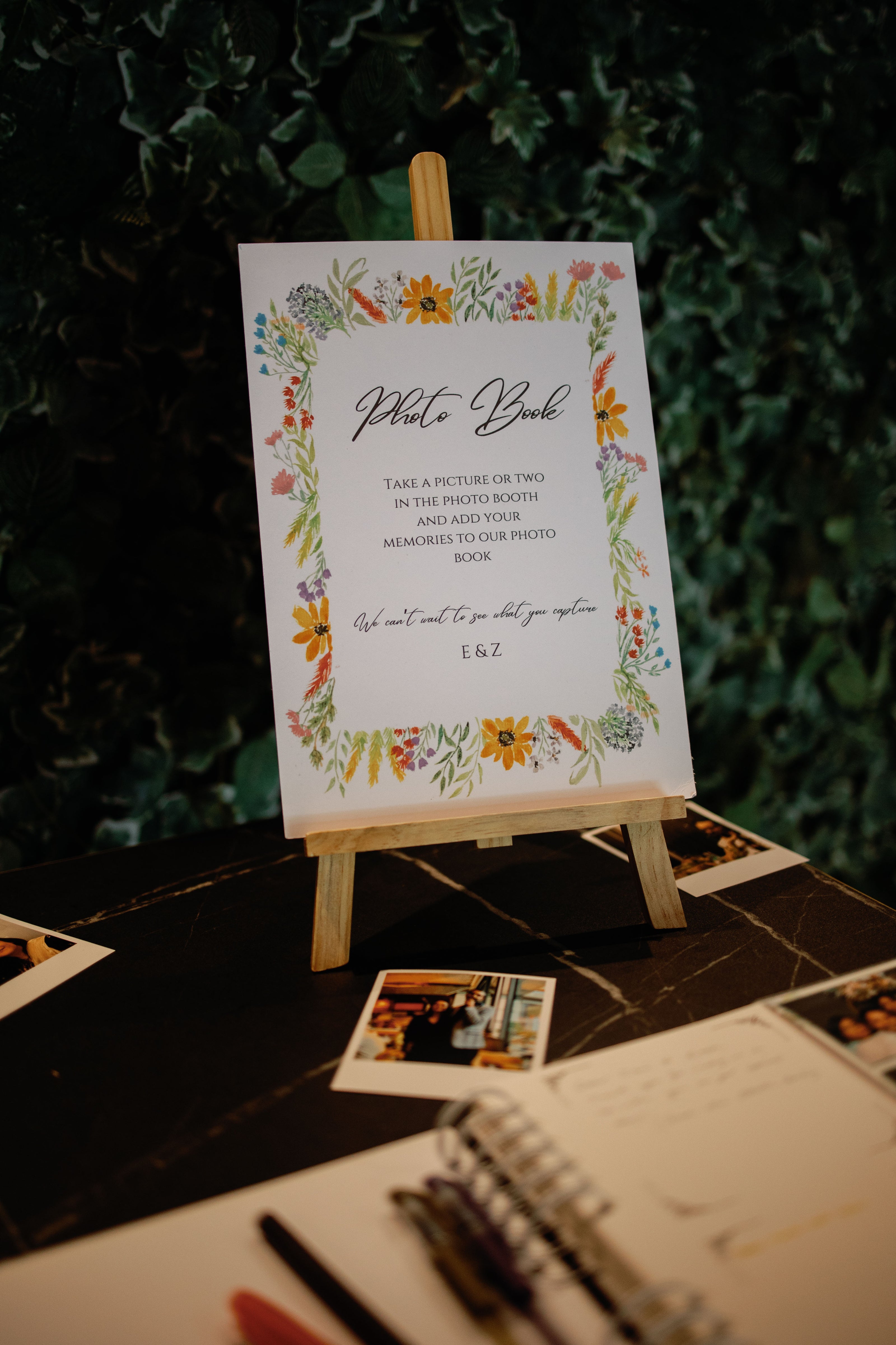 Invitation card on a small easel with floral design and text.