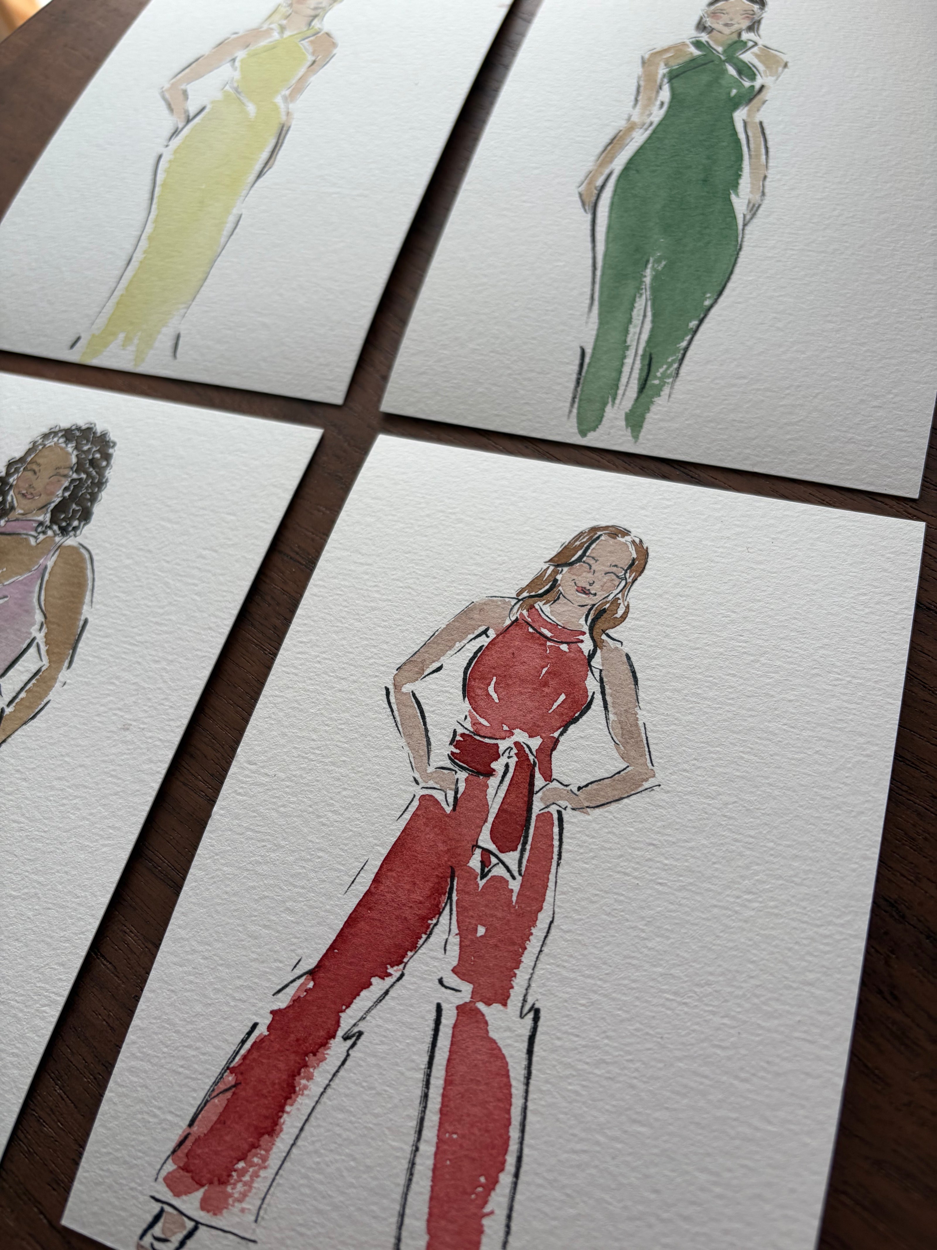 Collage of fashion sketches on a tiled surface
