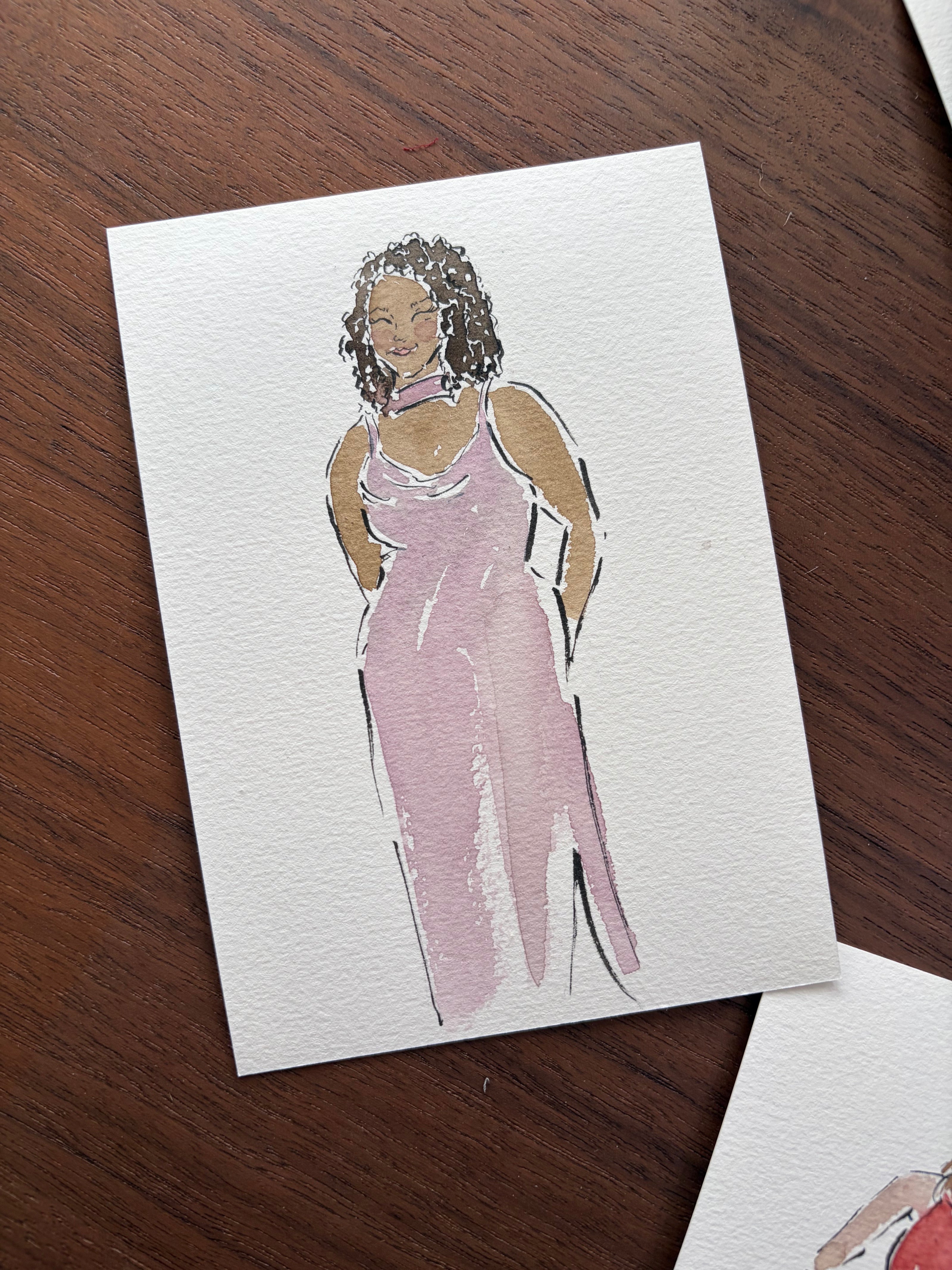 Card with a stylized illustration of a person on a wooden surface