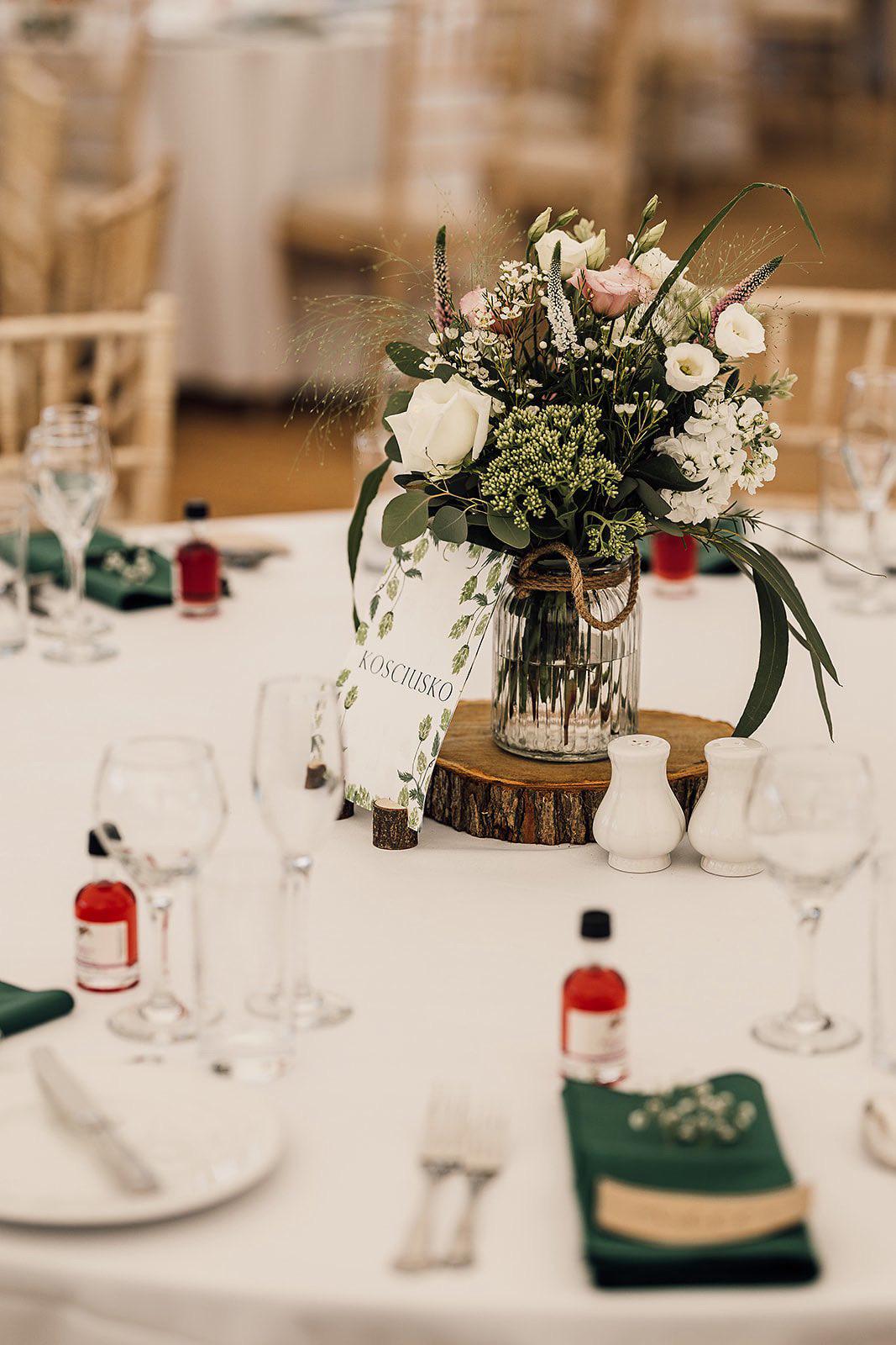 Decorative table setting with flowers and wine glasses in a blurred indoor setting
