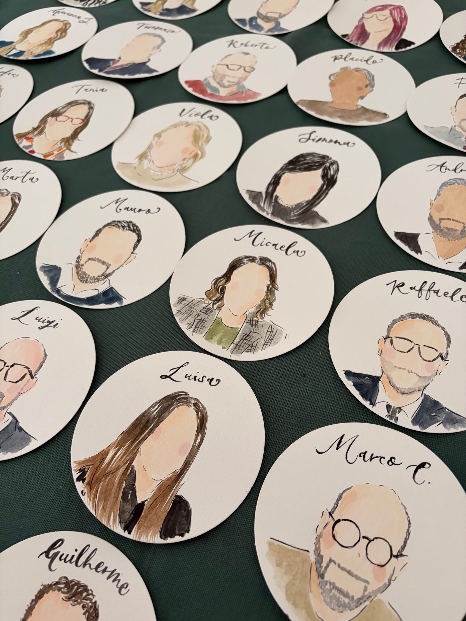 Circular coasters with hand-drawn portraits and calligraphy names