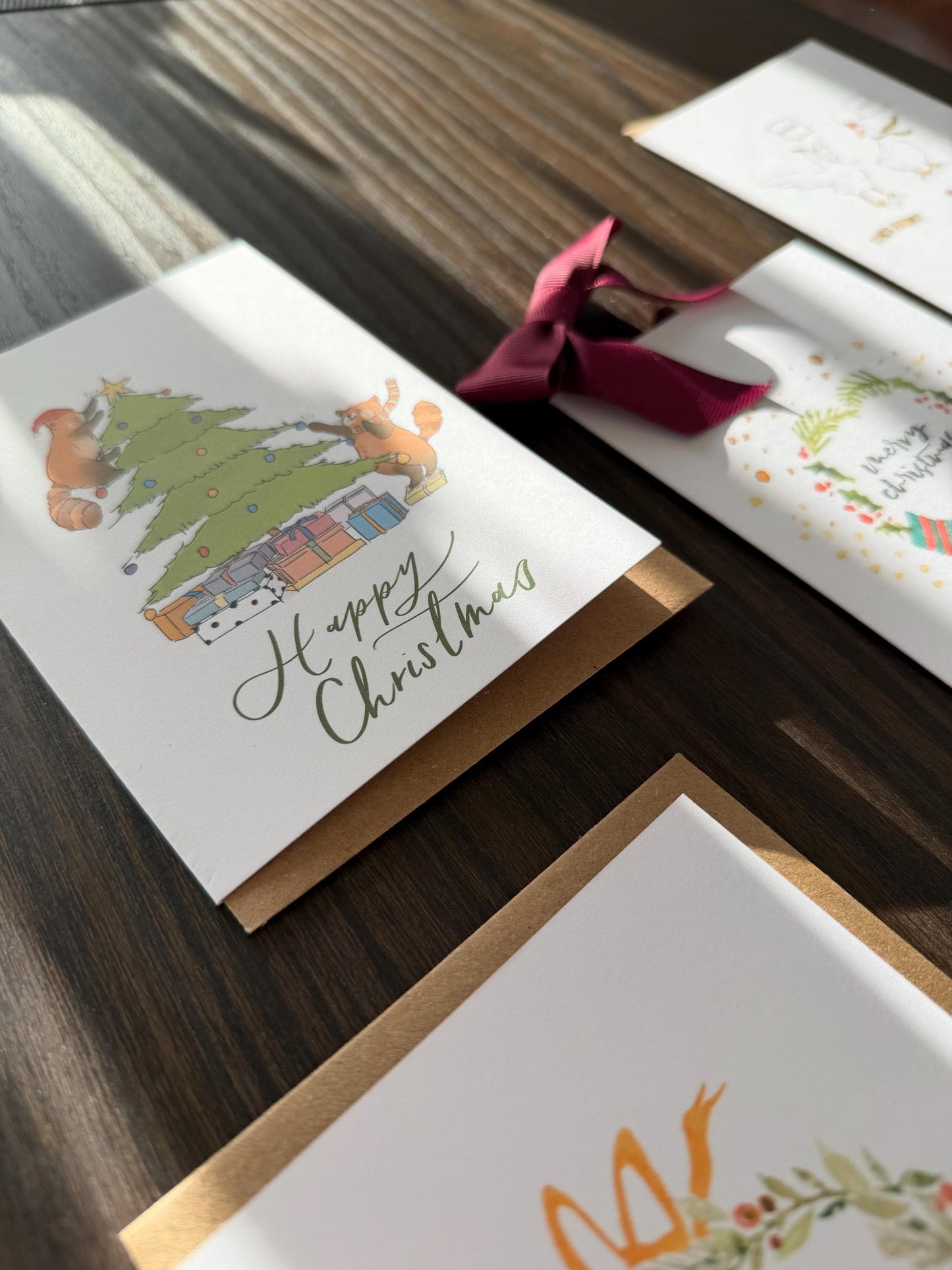 Christmas-themed greeting cards on a wooden surface