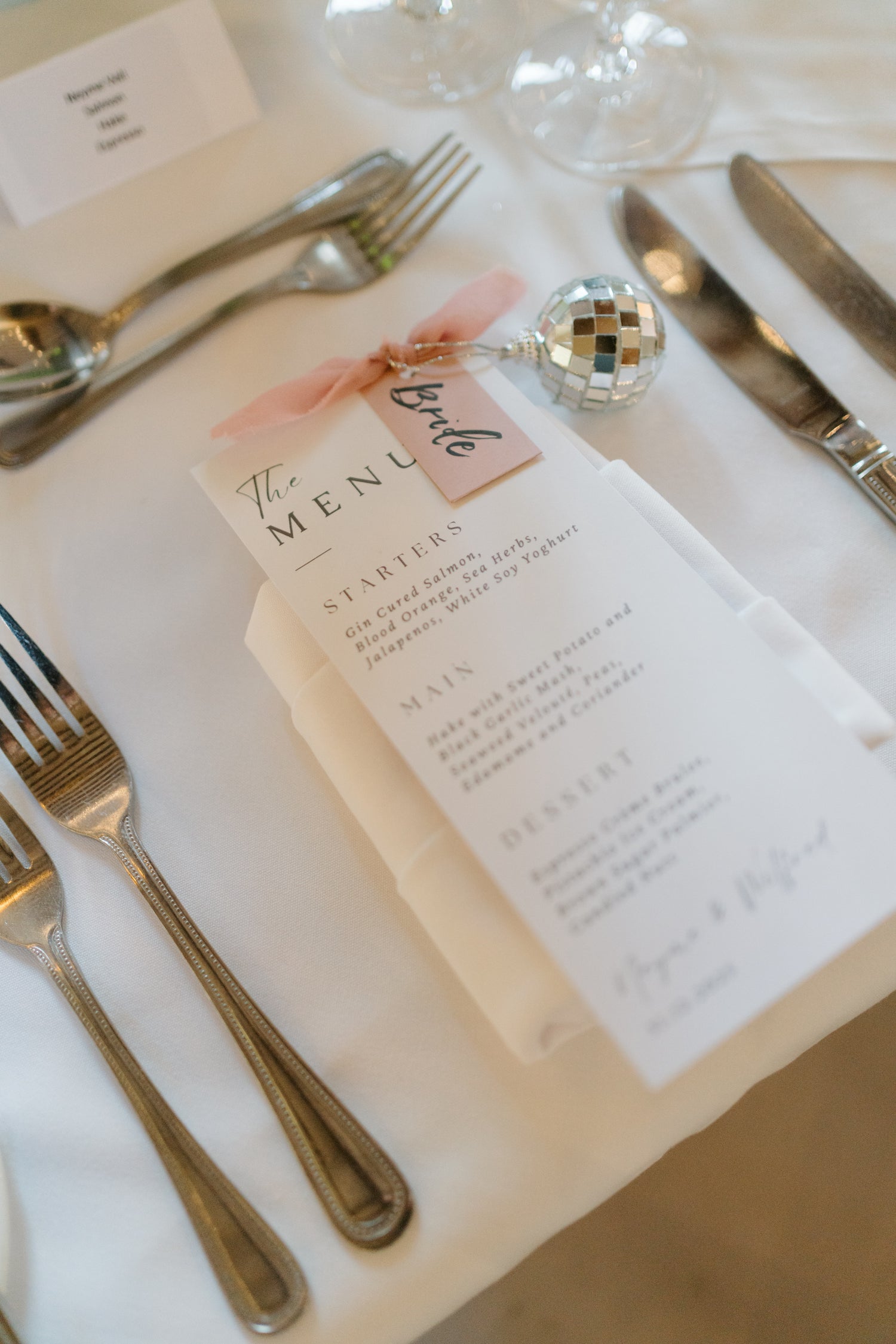 Table setting with wedding menu card with calligraphy name card